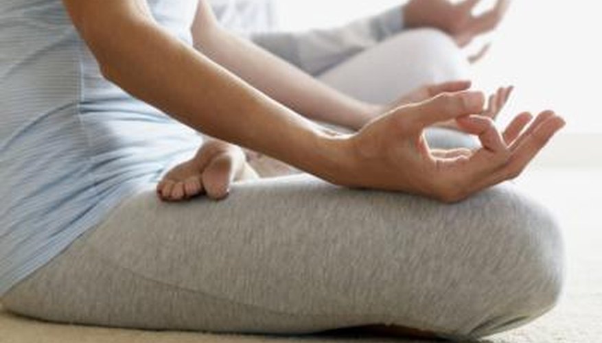 Woman mediates in yoga class Woman mediates in yoga class