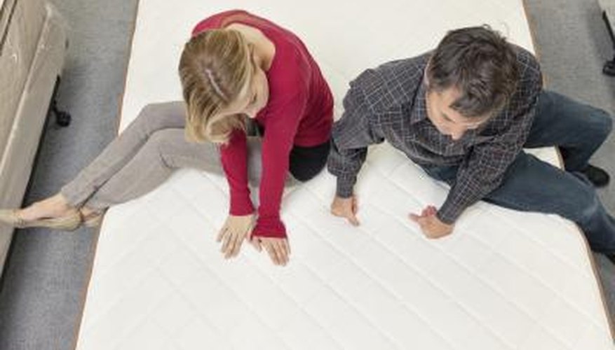 Couple testing new mattress at store Couple testing new mattress at store