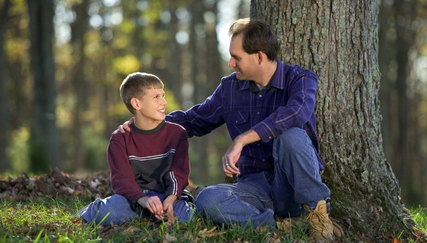 Father talking to son in park