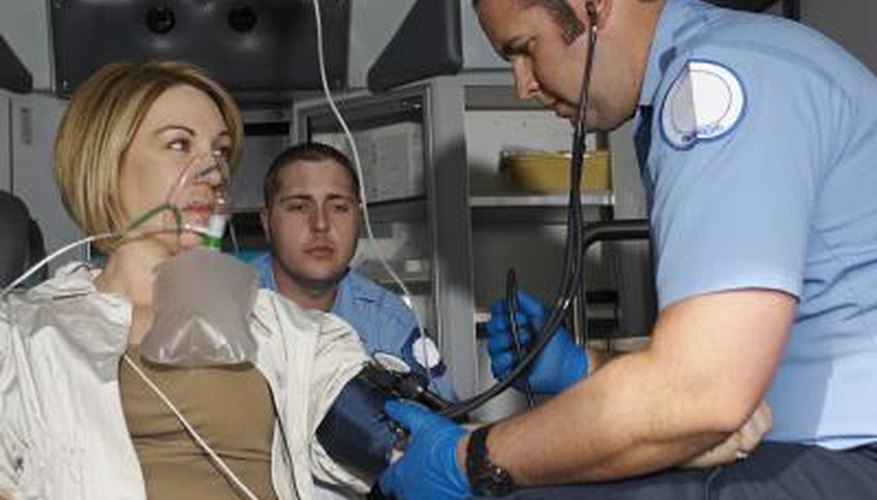 Paramedic assisting patient