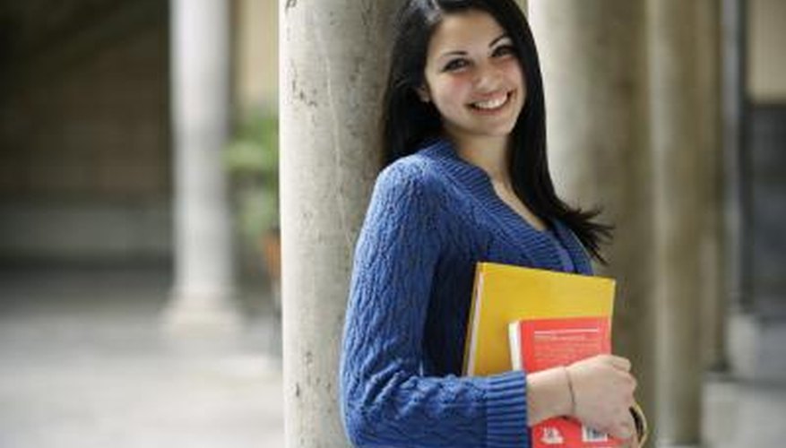 College student holding books on campus