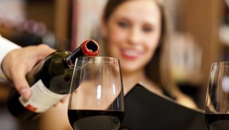 Photo Credit: Luca Francesco Giovanni Bertolli/iStock/Getty Images Waiter pouring wine