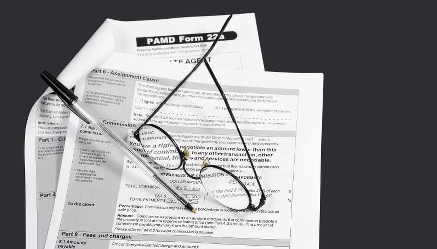 Close up of a contract with a pen and glasses