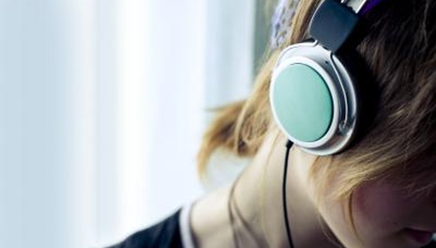 Photo Credit: Illya Vinogradov/iStock/Getty Images woman wearing headphones