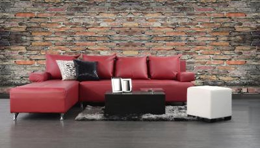 Red leather couch with contrasting block tables and throw pillows. Red leather couch with contrasting block tables and throw pillows.