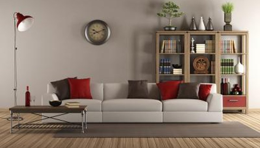 A long grey couch is mixed with a short and narrow wooden side table to offer contrast and complementary tastes. A long grey couch is mixed with a short and narrow wooden side table to offer contrast and complementary tastes.