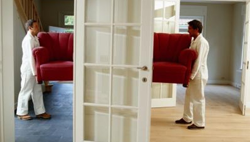 Photo Credit: David De Lossy/Photodisc/Getty Images Men remove sofa from house