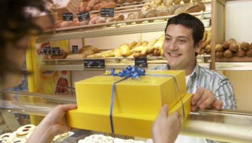 Photo Credit: RAYES/Photodisc/Getty Images A baker hands a customer a gift wrapped package.