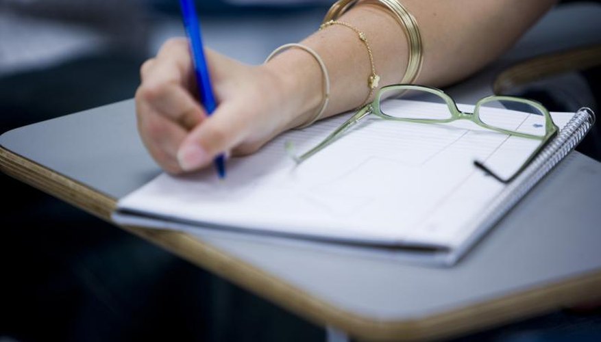 Close-up of student writing in notebook