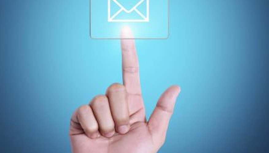 Photo Credit: denphumi/iStock/Getty Images Hand pressing email social media button.