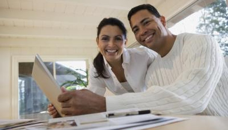 A man and woman are using a laptop together.