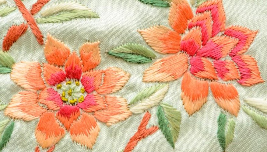 A close-up of pink and peach embroidered flowers. A close-up of pink and peach embroidered flowers.