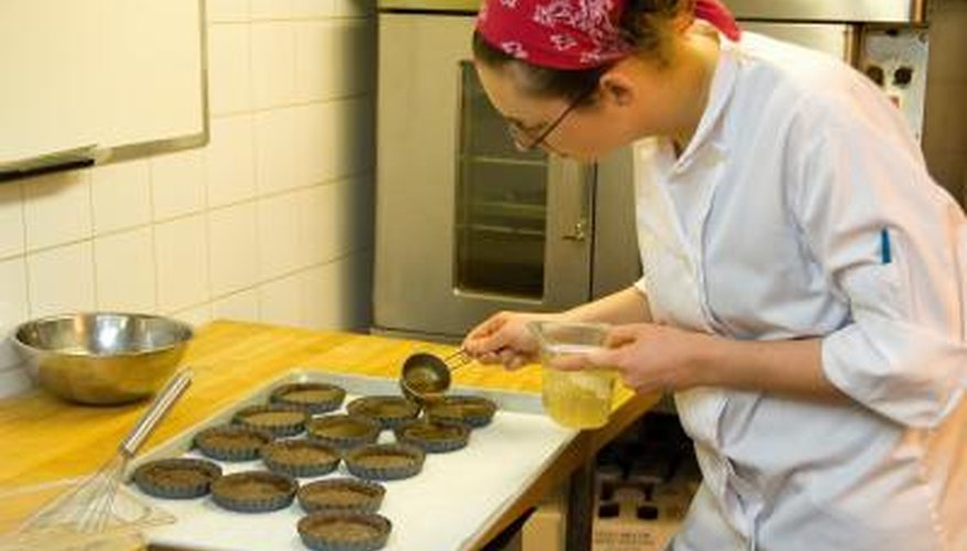 Photo Credit: Ingram Publishing/Ingram Publishing/Getty Images A pastry chef works in the kitchen.