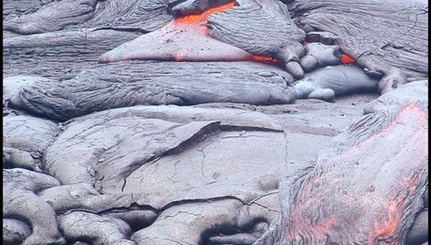 Cooled lava usually turns a black or grey color. Cooled lava usually turns a black or grey color.