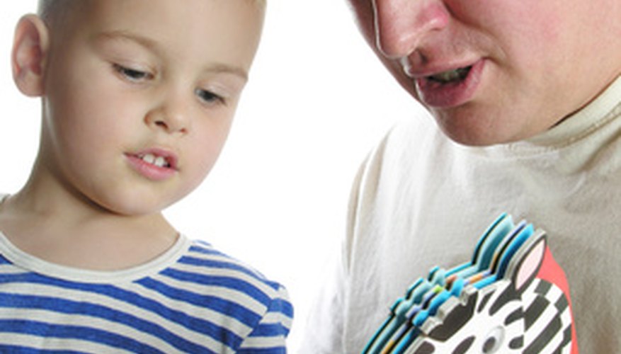 Photo Credit: father read book son image by Pavel Losevsky from <a href='http://www.fotolia.com'>Fotolia.com</a> The structure of a day care not only includes teachers, but parents and volunteers as well.