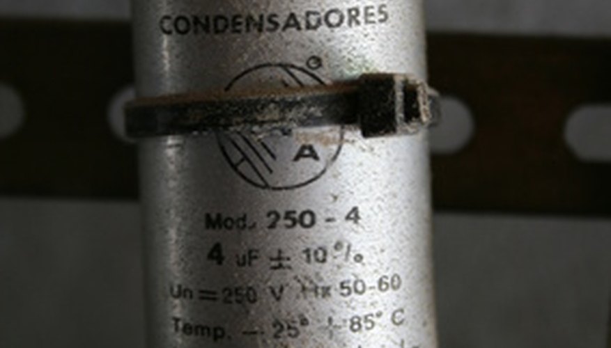 Photo Credit: condensadores image by Vanesa Boullosa Lopez from <a href='http://www.fotolia.com'>Fotolia.com</a> A capacitor starts a single-phase AC electric motor.