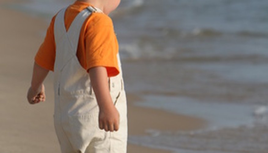 Photo Credit: boy on beach lake michigan great lake image by Paul Retherford from <a href='http://www.fotolia.com'>Fotolia.com</a> Ocean water covers 70 percent of the Earth's surface.