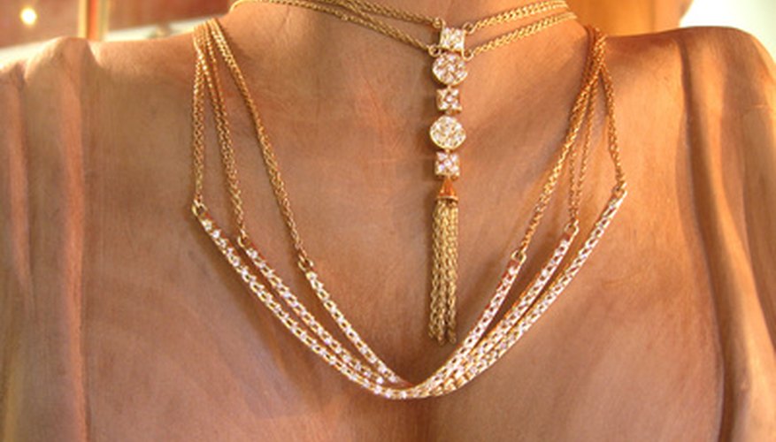 Photo Credit: jewelry image by Fata-Morgana from <a href='http://www.fotolia.com'>Fotolia.com</a> Gold jewelry can discolor from the metals found in some cosmetics.