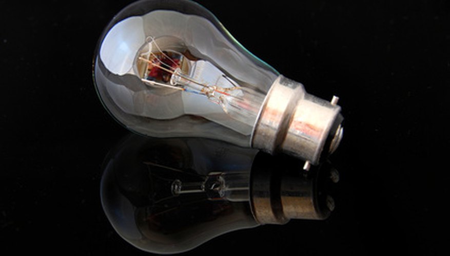 Photo Credit: Light bulb image by Mart61 from <a href='http://www.fotolia.com'>Fotolia.com</a> Incandescents waste more watts in heat than fluorescents.