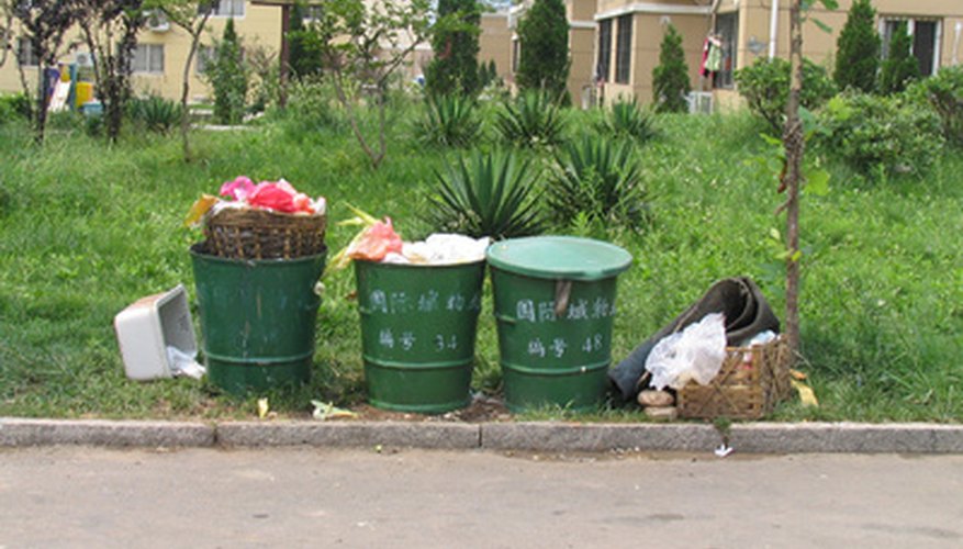 Keep the lids on your garbage cans with a heavy brick. Keep the lids on your garbage cans with a heavy brick.