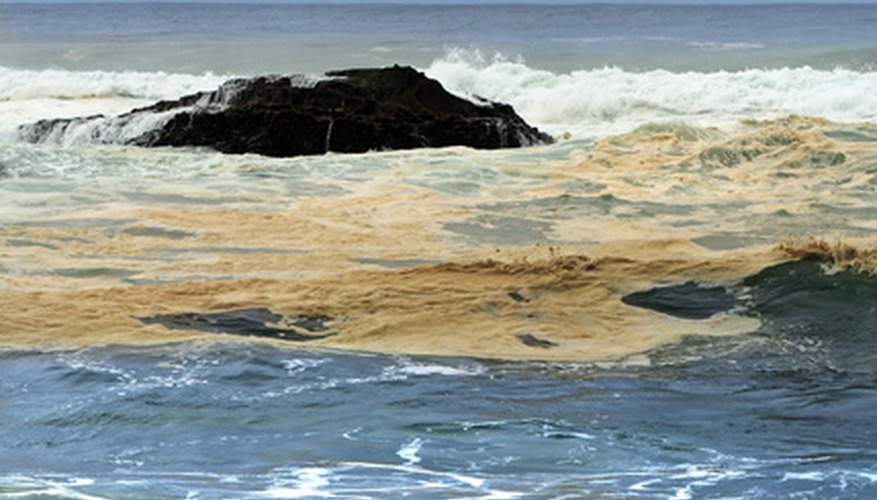 Photo Credit: contamination image by Aleksander from <a href='http://www.fotolia.com'>Fotolia.com</a> Oil spills threaten humans and wildlife.