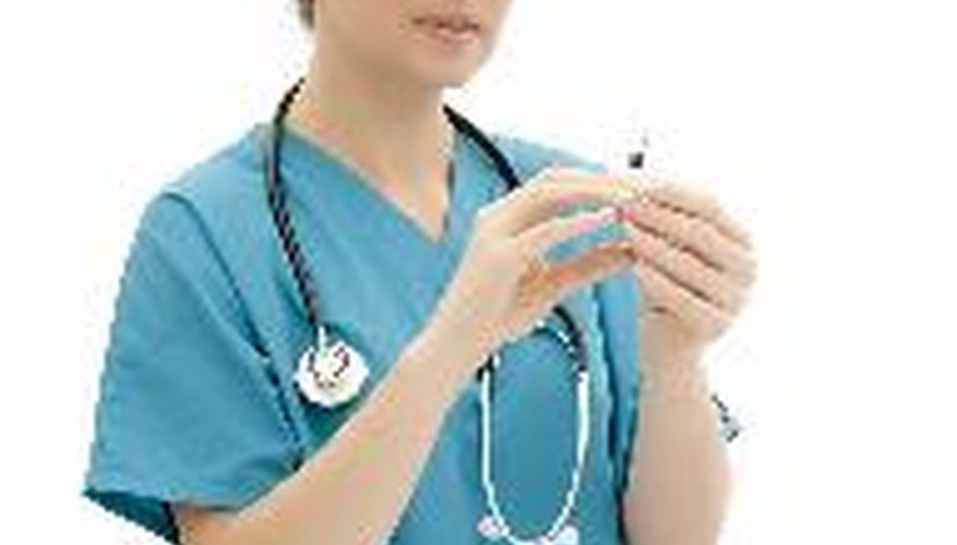 Photo Credit: Vet preparing an injection image by Sophia Winters from <a href='http://www.fotolia.com'>Fotolia.com</a> Your veterinarian can determine whether your dog's panicky behavior is caused by a medical problem.