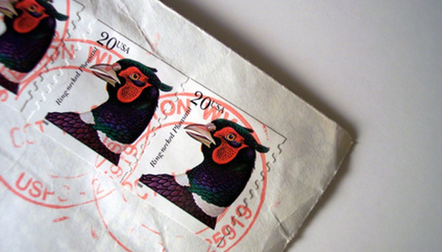 Photo Credit: USA stamp image by timur1970 from <a href='http://www.fotolia.com'>Fotolia.com</a> First-Class Mail includes letters, postcards, and packages.