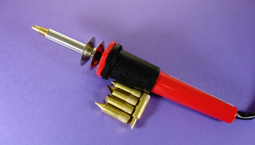 Photo Credit: soldering woodburning kit image by Steve Johnson from <a href='http://www.fotolia.com'>Fotolia.com</a> Soldering only melts the solder.