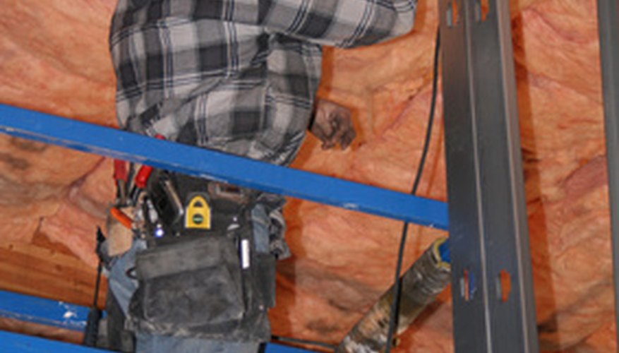 Photo Credit: construction worker, image by Greg Pickens from <a href='http://www.fotolia.com'>Fotolia.com</a> A beam's dimensions determine its strength.