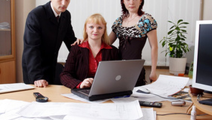 Photo Credit: cooperation image by Andrey Kiselev from <a href='http://www.fotolia.com'>Fotolia.com</a> Democratic leadership inspires cooperation among employees.