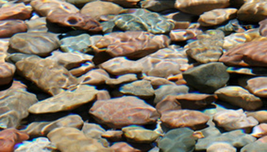 Photo Credit: river rocks image by MAXFX from <a href='http://www.fotolia.com'>Fotolia.com</a> Customize the size and shape of river rocks in a rock tumbler.