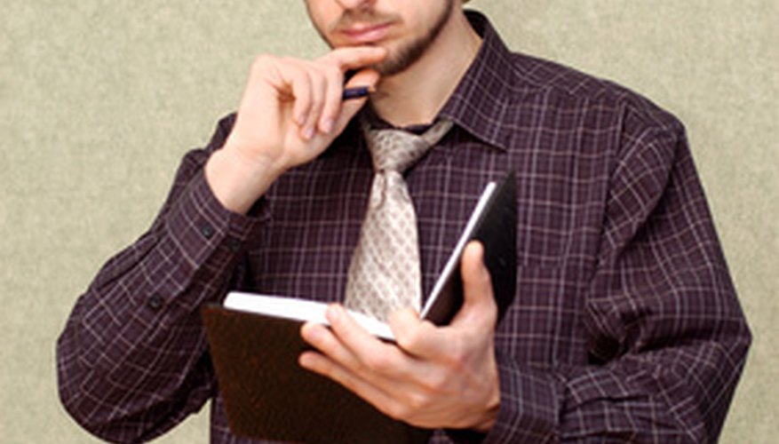 Photo Credit: office worker concentrating image by Mykola Velychko from <a href='http://www.fotolia.com'>Fotolia.com</a> Encourage the new employee to take notes that might help him orient to his environment.