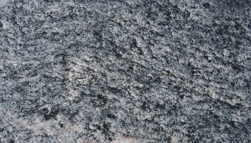 Photo Credit: the uneven surface of the stone image by alri from <a href='http://www.fotolia.com'>Fotolia.com</a> Drains must accommodate rainfall that is not absorbed by the ground.