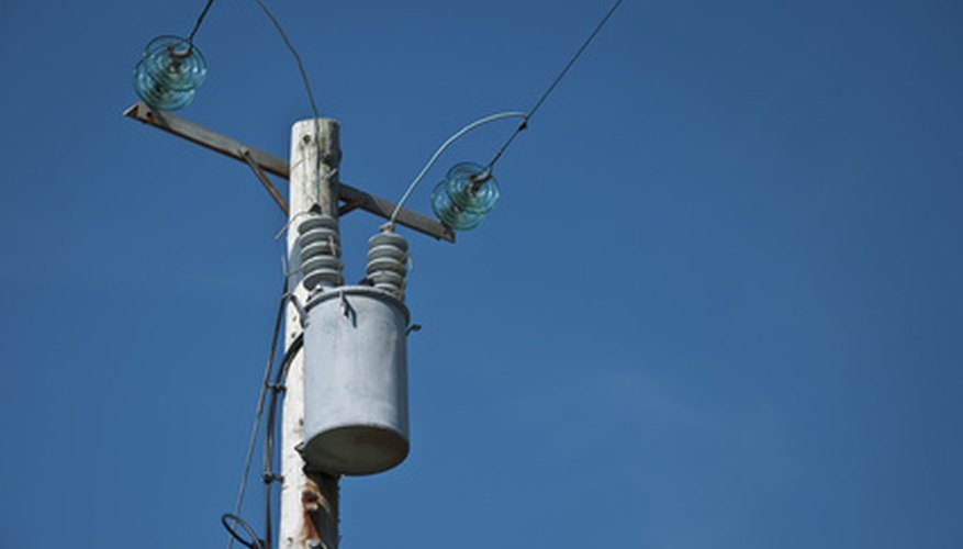 Photo Credit: electrical power line and transformer with blue sky image by noel moore from <a href='http://www.fotolia.com'>Fotolia.com</a> Transformers are necessary to bring power to homes.