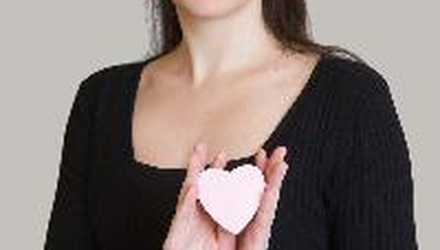 woman with heart on a grey background
