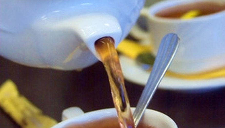 Photo Credit: golden tea image by Indigo Fish from <a href='http://www.fotolia.com'>Fotolia.com</a> A tea-party themed bridal shower sets the place for a wide array of food choices.