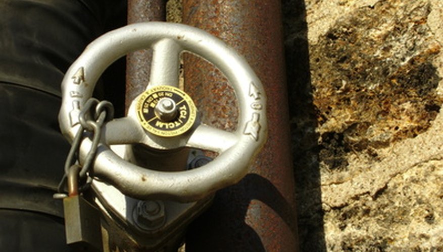 Photo Credit: valve image by J-F Perigois from <a href='http://www.fotolia.com'>Fotolia.com</a> A hydraulic valve controls pressurised fluid used in hydraulic systems.