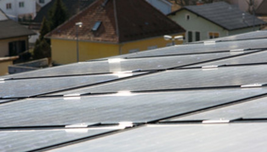 Photo Credit: Solar panels on roof image by kuhar from <a href='http://www.fotolia.com'>Fotolia.com</a> Urban environments can be a challenge for solar energy due to space limitations