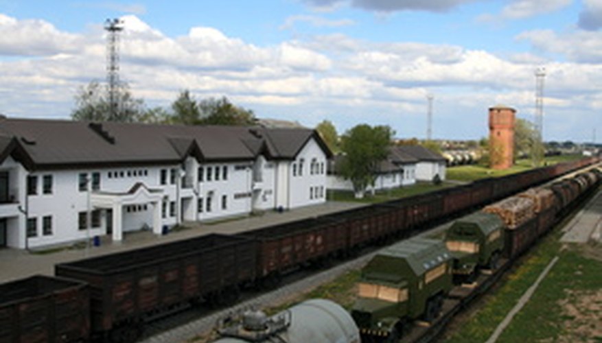 Photo Credit: rail freight image by Nikon'as from <a href='http://www.fotolia.com'>Fotolia.com</a> Cylindrical oils tanks, like this rail road tanker, can be calculated with a simple volume formula.