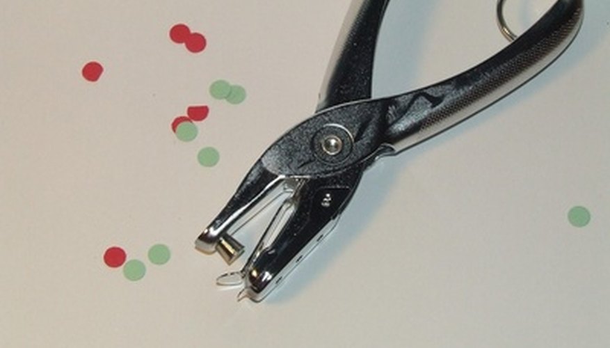 Photo Credit: hole punch image by robert mobley from <a href='http://www.fotolia.com'>Fotolia.com</a> A handheld single hole punch.