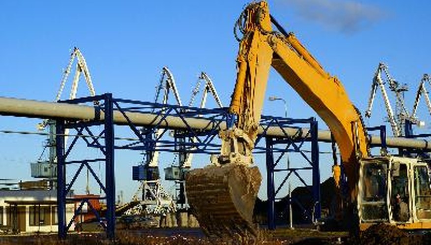 Hydraulic excavator at work. Shovel bucket against blue sky