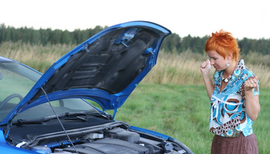 young red-haired woman with her broken car.