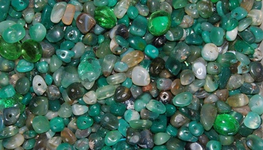 Photo Credit: greenbeads image by TekinT from <a href='http://www.fotolia.com'>Fotolia.com</a> Polished stones ready for making jewelry.