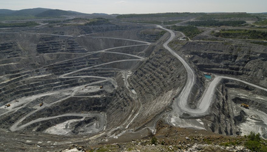 Photo Credit: excavation image by apeschi from <a href='http://www.fotolia.com'>Fotolia.com</a> Pit mine.