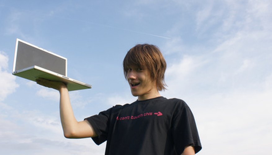 Photo Credit: boy whit laptop in hand image by kuhar from <a href='http://www.fotolia.com'>Fotolia.com</a> Computer programming can play a major role in your senior project.