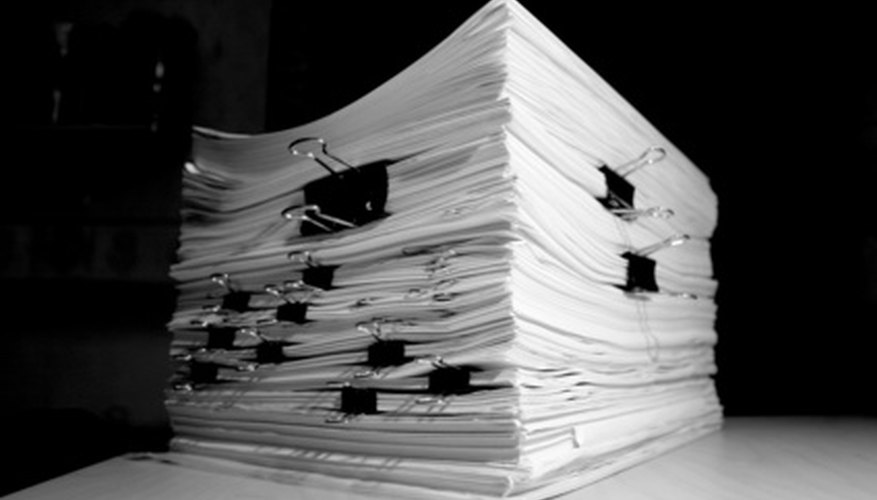 Photo Credit: pile of papershets with paper-clips #2 image by stassad from <a href='http://www.fotolia.com'>Fotolia.com</a> Paperwork