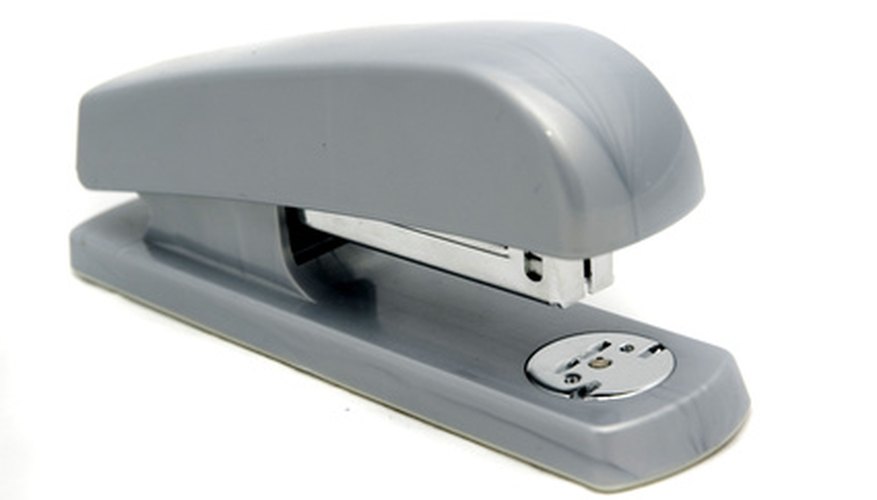 Photo Credit: the new stapler image by Rich Johnson from <a href='http://www.fotolia.com'>Fotolia.com</a> A stapler is a typical desk supply.