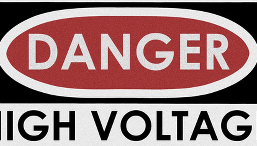Photo Credit: danger, high voltage image by Alexander from <a href='http://www.fotolia.com'>Fotolia.com</a> A step-down transformer reduces high-voltage AC input for use in a lower voltage power supply.