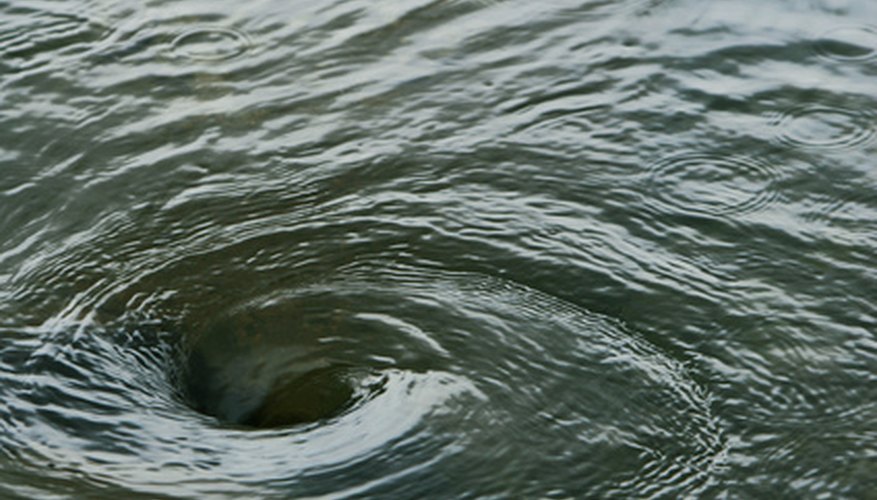 Photo Credit: water vortex image by sumos from <a href='http://www.fotolia.com'>Fotolia.com</a> The colored oil will create a typhoon vortex inside your bottle.