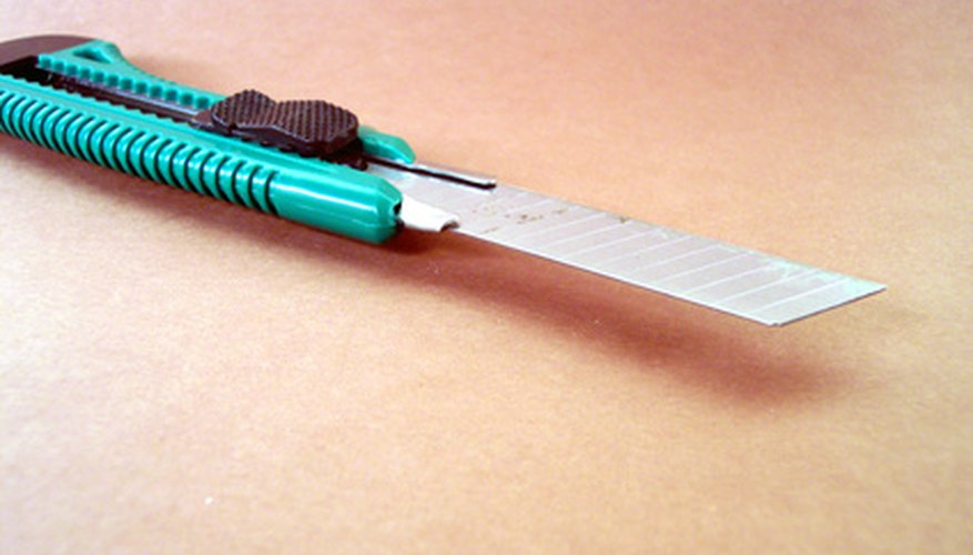 Photo Credit: a sharp utility knife image by timur1970 from <a href='http://www.fotolia.com'>Fotolia.com</a> Use a knife to scratch the minerals.